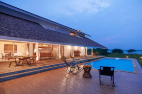 StayVista's Eva Villa - Lakeside Luxury with Modern Decor, Pool & Expansive Lawn - Near Sula